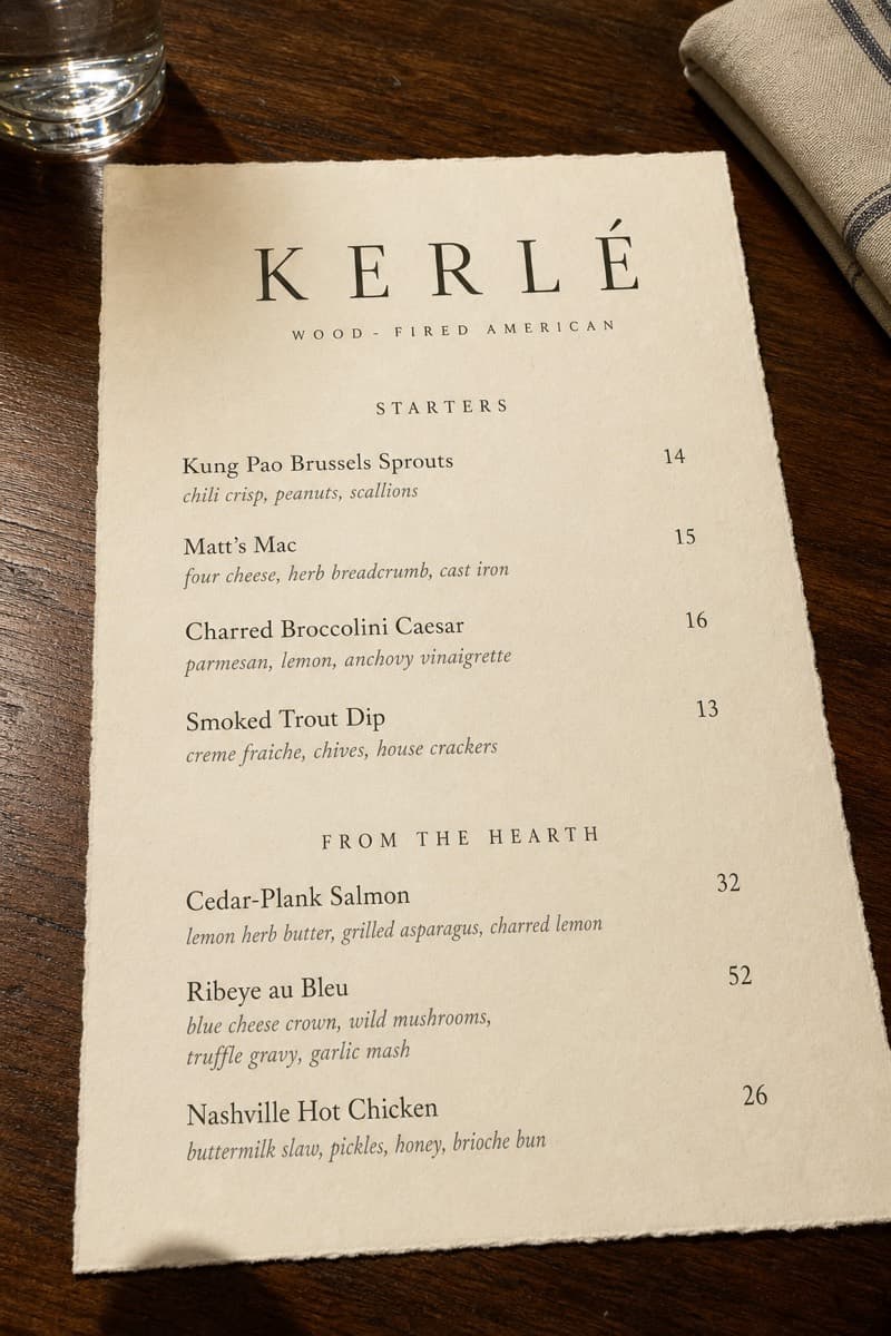 Photograph of a restaurant menu page listing starters and hearth dishes at Kerlé.